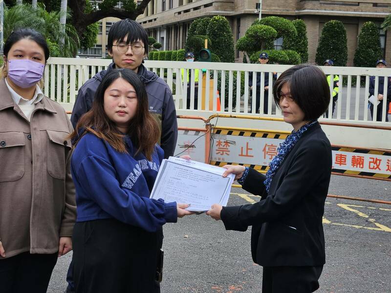 有團體代表(左)4日在行政院門口遞交陳情,盼政府暫緩新增移工來源國。(Photo by 呂翔禾/台灣醒報)
